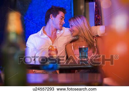 Stock Image - Young couple in a bar. Fotosearch