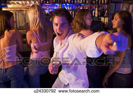 Stock Image - Young man in a bar. Fotosearch