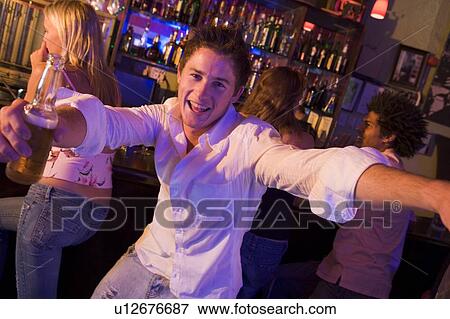 Stock Photo - Young man in a bar. Fotosearch