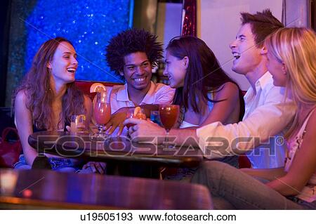 Young people at a bar View Large Photo Image Stock Image - Young people at a bar. Fotosearch