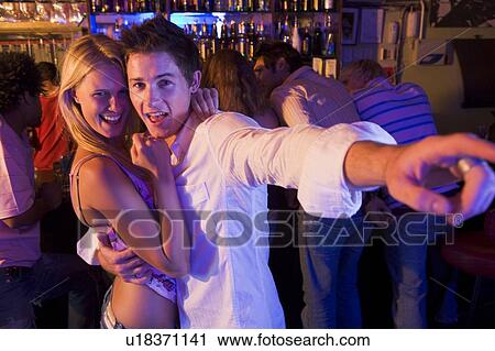 Young people dancing in a bar View Large Photo Image Stock Image - Young people dancing in a bar. Fotosearch