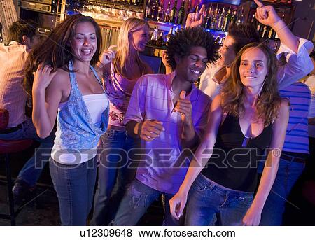Stock Photo - Young people dancing in a bar. Fotosearch