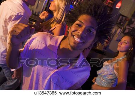 Young people dancing in a bar View Large Photo Image Stock Photography - Young people dancing in a bar. Fotosearch