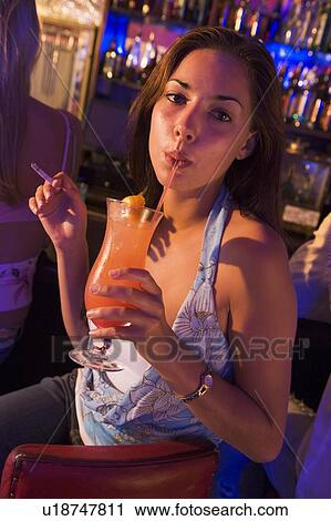 Young woman in a bar smoking View Large Photo Image Stock Image - Young woman in a bar smoking. Fotosearch