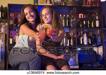 Picture - Young women in a bar. Fotosearch