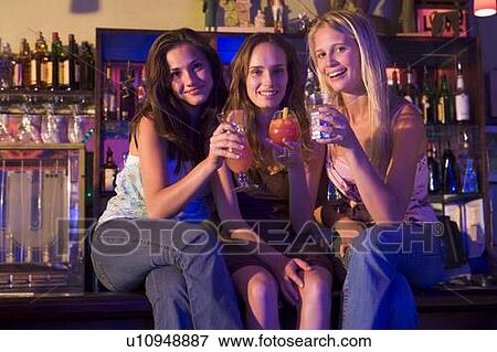 Young women in a bar View Large Photo Image Stock Photo - Young women in a bar. Fotosearch