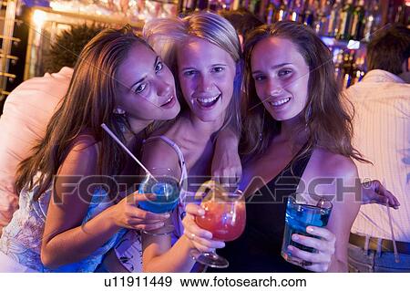 Stock Photo - Young women in a bar. Fotosearch