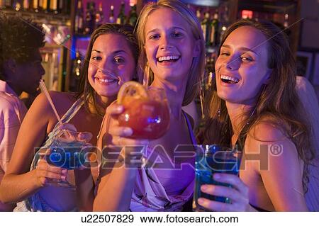 Young women in a bar View Large Photo Image Stock Photo - Young women in a bar. Fotosearch