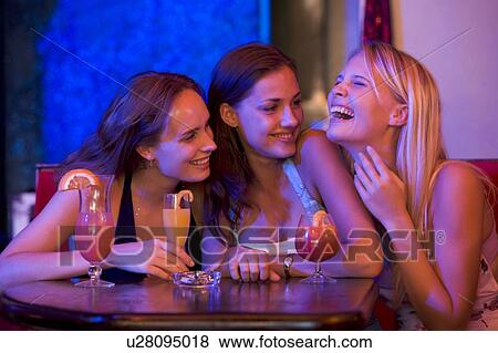 Stock Photo - Young women in a bar. Fotosearch