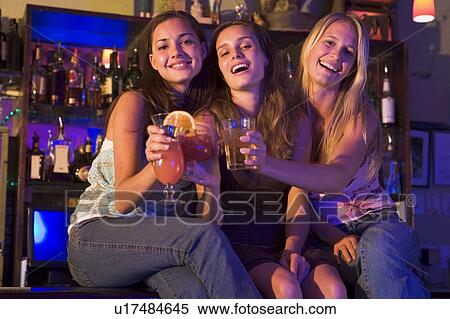 Young women in a bar View Large Photo Image Stock Photography - Young women in a bar. Fotosearch