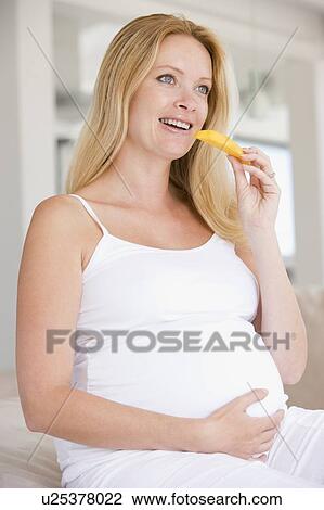Pregnant woman eating melon slice and smiling View Large Photo Image Stock Image - Pregnant woman eating melon slice and smiling. Fotosearch