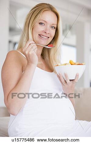 Pregnant woman with bowl of fruit salad smiling View Large Photo Image Stock Photograph - Pregnant woman with bowl of fruit salad smiling. Fotosearch