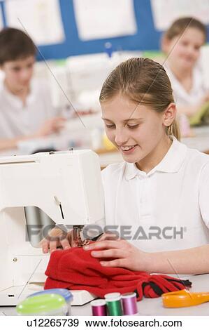Female student using sewing machine View Large Photo Image Stock Photo - Female student using sewing machine. Fotosearch