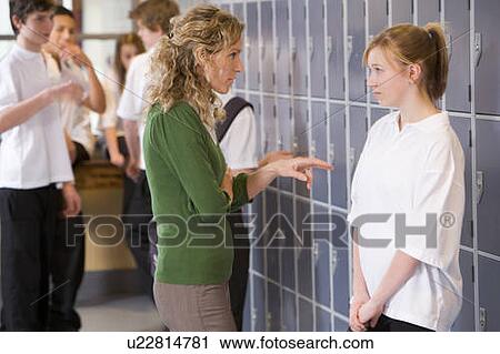 Stock Image - Female teacher reprimanding a female student. Fotosearch