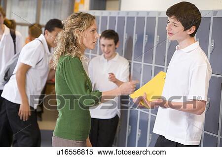 Stock Photography - Female teacher reprimanding a male student. Fotosearch
