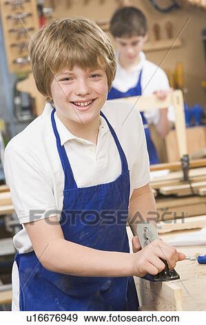 Male student learning woodworking View Large Photo Image Stock Photo - Male student learning woodworking. Fotosearch