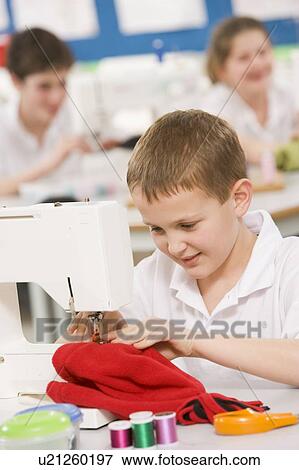 Stock Photo - Male student using sewing machine. Fotosearch