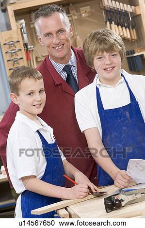 Male students reviewing woodworking plans with teacher View Large Photo Image Stock Image - Male students reviewing woodworking plans with teacher. Fotosearch