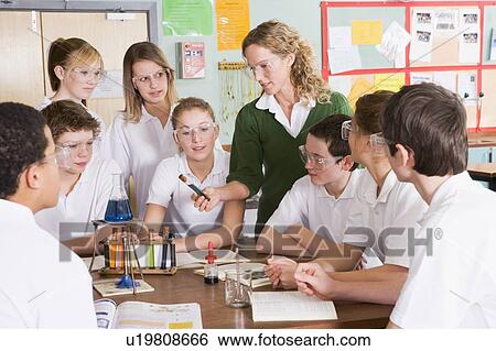 Stock Photograph - Students receiving chemistry lesson in classroom. Fotosearch