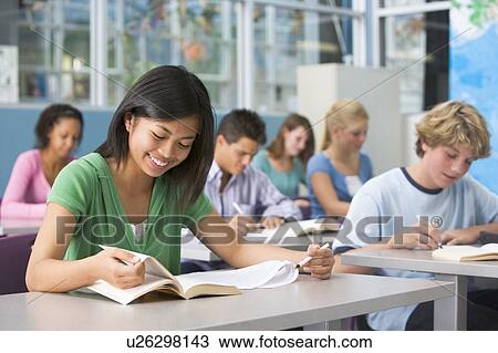 Stock Image - Students studying in geography class. Fotosearch