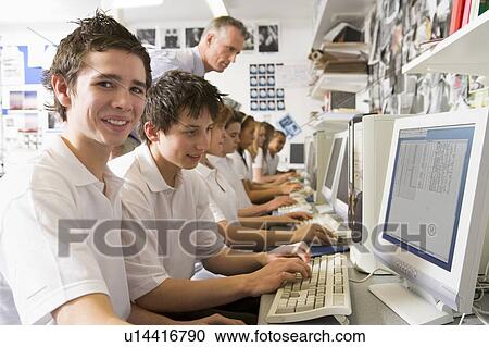 Students working on computer workstations with teacher View Large Photo Image Stock Image - Students working on computer workstations with teacher. Fotosearch