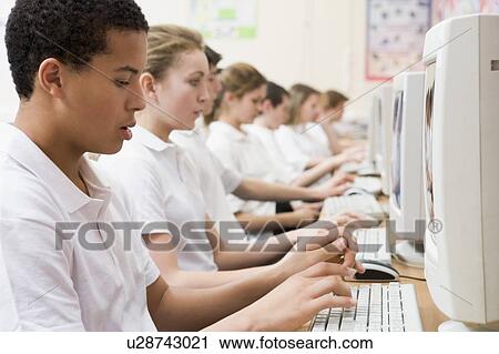 Stock Image - Students working on computer workstations. Fotosearch