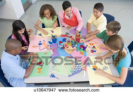 Stock Photo - Teacher and students in art class. Fotosearch