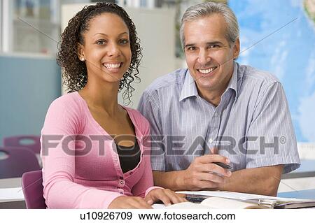 Stock Photo - Teacher giving personal instruction to female student. Fotosearch