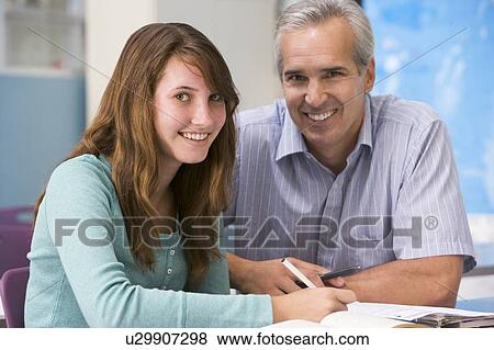 Stock Photo - Teacher giving personal instruction to female student. Fotosearch
