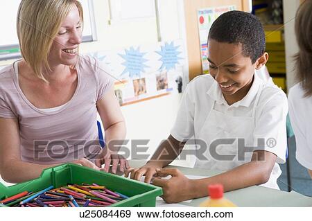 Stock Photo - Student in art class with teacher. Fotosearch