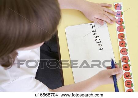 Picture - Student in class learning numbers (selective focus). Fotosearch