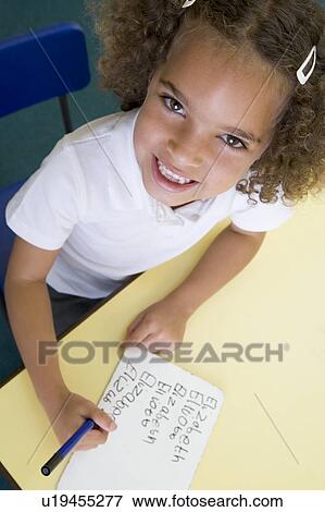Stock Photo - Student in class learning spelling (selective focus). Fotosearch