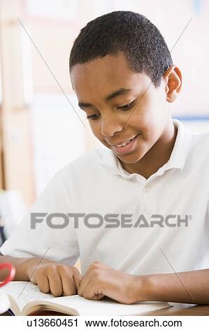 Student in class reading book (high key) View Large Photo Image Stock Image - Student in class reading book (high key). Fotosearch