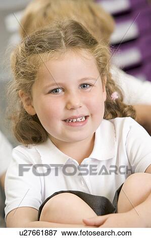 Stock Photo - Student in class sitting on floor (selective focus). Fotosearch