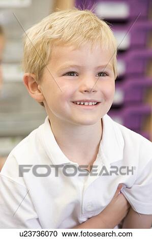 Stock Image - Student in class smiling (selective focus). Fotosearch