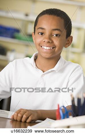 Stock Photo - Student in class taking notes. Fotosearch