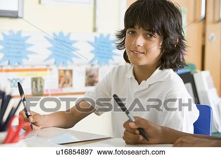 Student in class taking notes View Large Photo Image Stock Photo - Student in class taking notes. Fotosearch