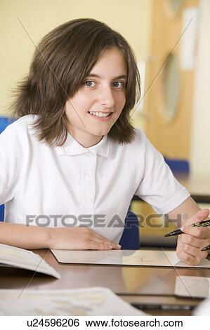 Student in class taking notes View Large Photo Image Stock Photograph - Student in class taking notes. Fotosearch
