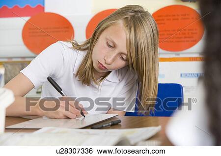 Student in class taking notes View Large Photo Image Stock Photograph - Student in class taking notes. Fotosearch