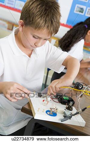 Stock Photo - Student in class with electronic project (selective focus). Fotosearch