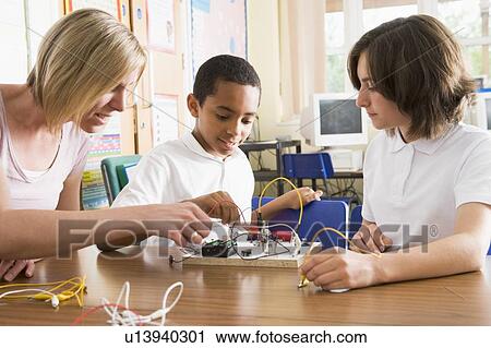 Students and teacher in class with electronic project View Large Photo Image Stock Image - Students and teacher in class with electronic project. Fotosearch