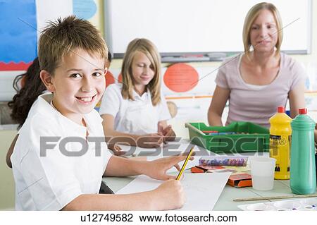Stock Image - Students in art class with teacher (selective focus). Fotosearch
