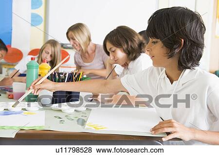 Stock Photo - Students in art class with teacher (depth of field). Fotosearch