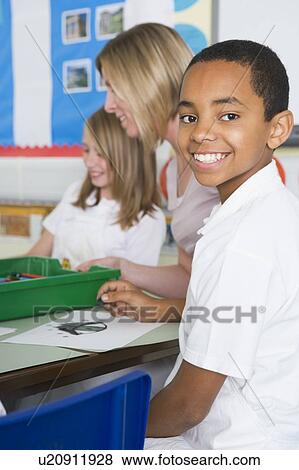 Stock Photo - Students in art class with teacher (selective focus). Fotosearch