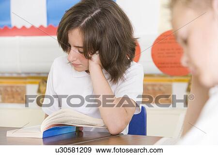 Students in class reading book (selective focus) View Large Photo Image Stock Photo - Students in class reading book (selective focus). Fotosearch