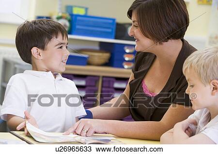 Students in class with teacher reading View Large Photo Image Stock Image - Students in class with teacher reading. Fotosearch