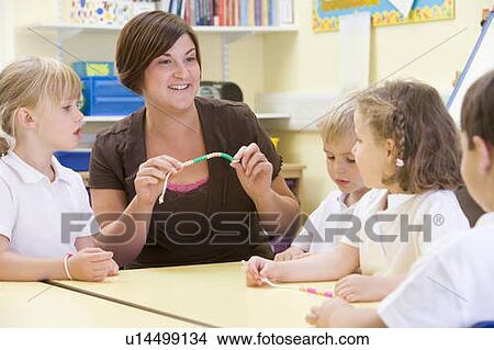Picture - Students in math class using counting beads (selective focus). Fotosearch