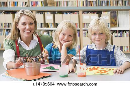 Two students in art class with teacher View Large Photo Image Picture - Two students in art class with teacher. Fotosearch