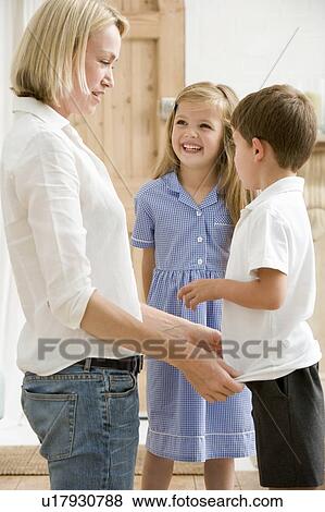 Woman in front hallway with two young children smiling View Large Photo Image Stock Photo - Woman in front hallway with two young children smiling. Fotosearch
