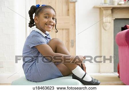 Young girl in front hallway fixing shoe and smiling View Large Photo Image Stock Image - Young girl in front hallway fixing shoe and smiling. Fotosearch